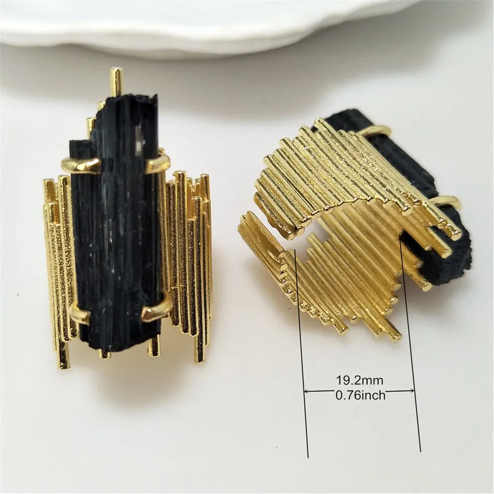 Gold and black earrings with measurements on a white background
